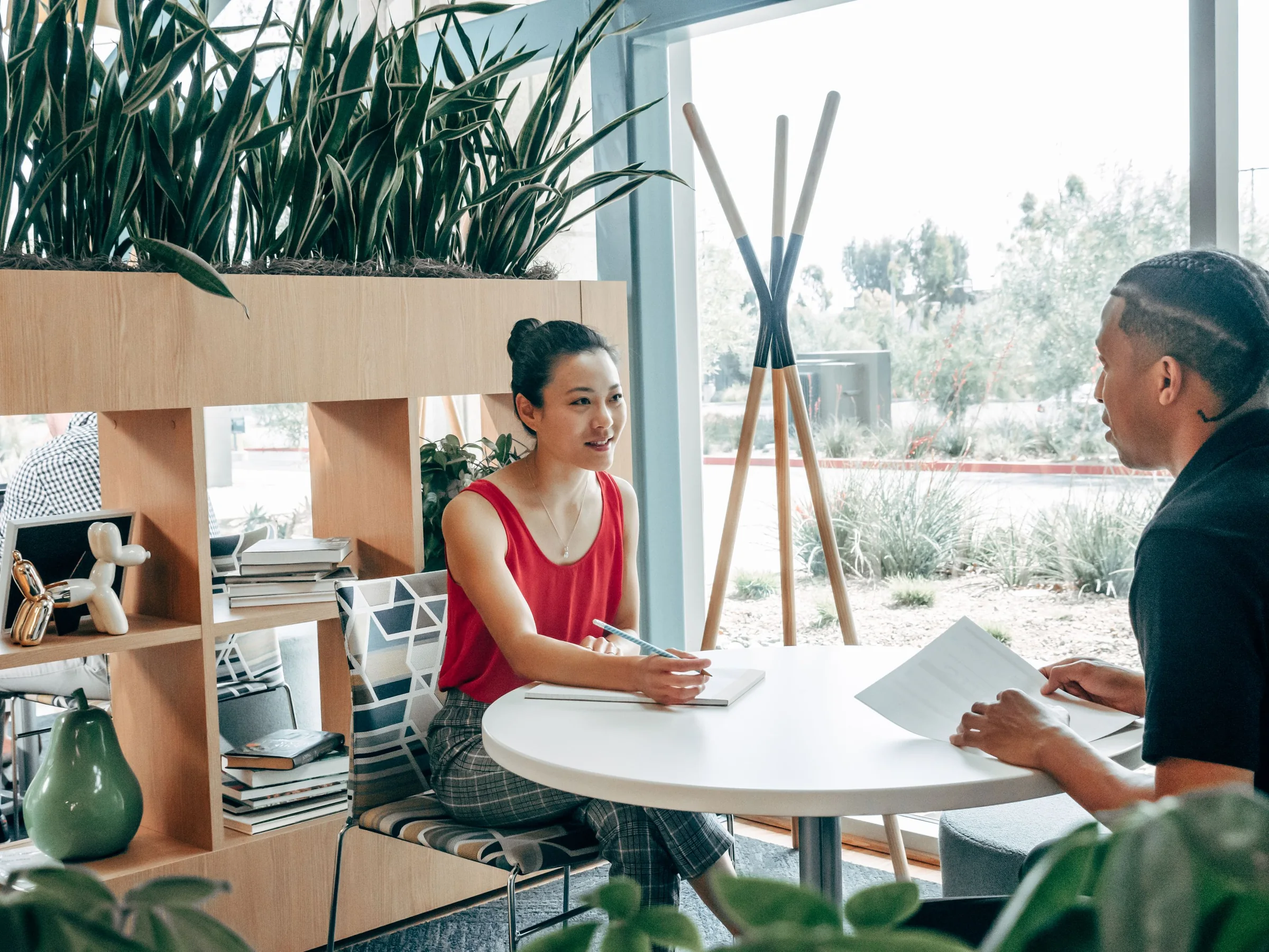 A founder interviewing a candidate at a small round table in an office